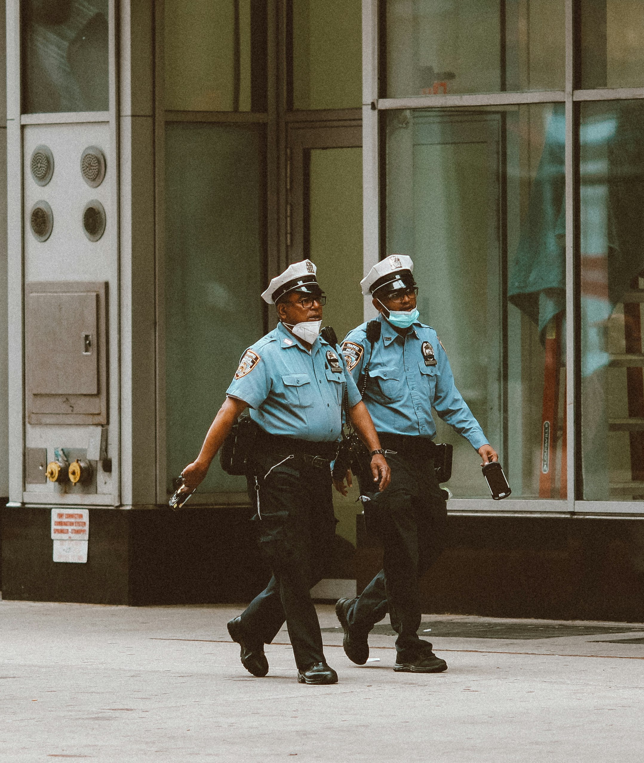 2 men in blue shirt and black pants wearing helmet